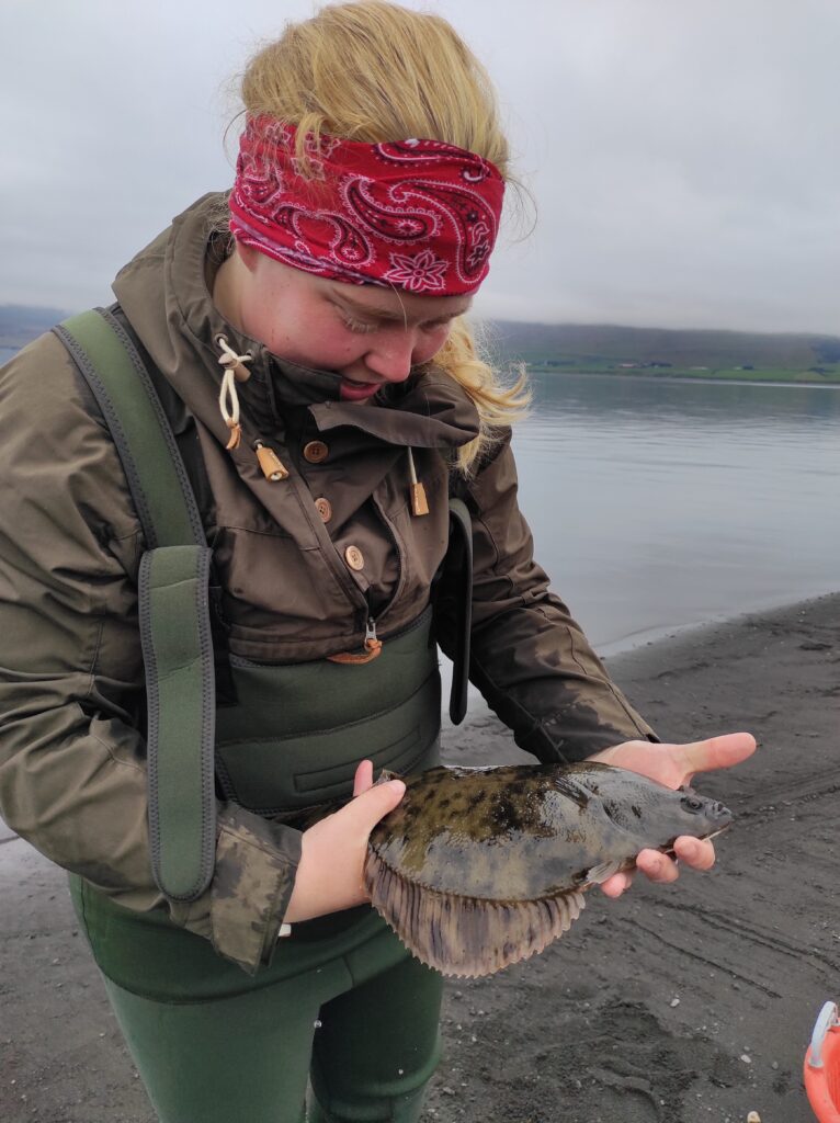 Theresa is holding a big flounder